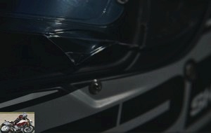 The visor is held in the closed position by a metal lug